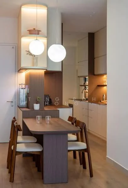 Dining features: wooden dining table, 4 wooden dining chairs with cushions, pendant lighting with round glass shades, light wood flooring, white painted walls, built-in cabinetry with light wood finish, kitchen area visible in background, countertop with under-cabinet lighting; style: modern.