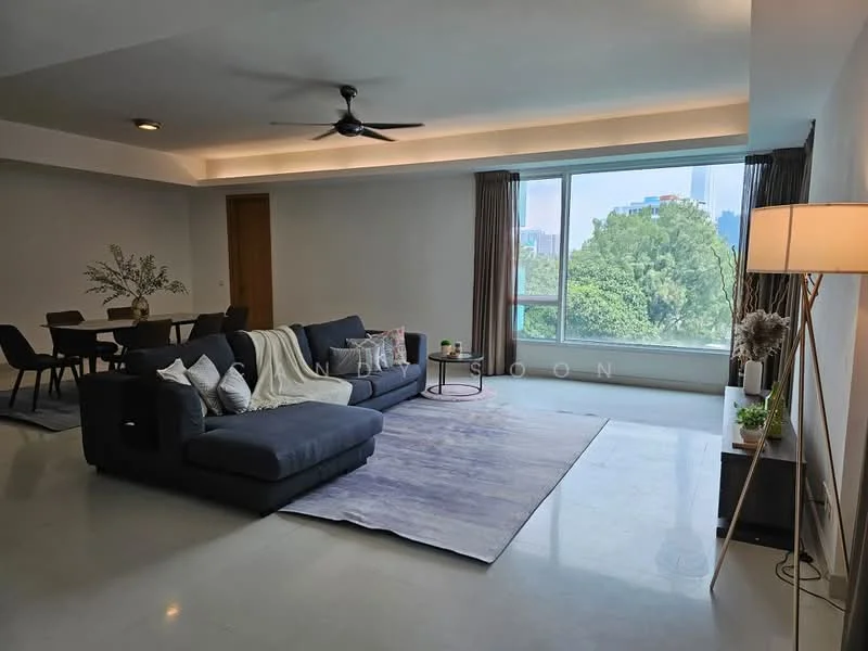 Living features: grey fabric sectional sofa, area rug with geometric pattern, floor-to-ceiling windows, sheer curtains, ceiling fan, wall-mounted lamp, decorative throw pillows, coffee table, dining table with chairs visible in background; style: modern; view: garden.