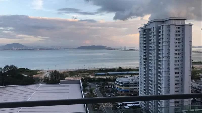 Exterior type: high-rise condominium; features: view of the sea, city skyline in background, surrounded by water, near beach area, adjacent to highway, multiple high-rise buildings visible; style: modern.