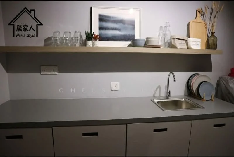 Kitchen features: grey countertop, single-bowl stainless-steel sink, chrome pull-down faucet, white cabinetry with flat-panel design, open shelving above countertop, glassware on shelf, wooden cutting board, decorative vase with dried plants, ceramic plates, wall-mounted electrical outlet; style: modern.