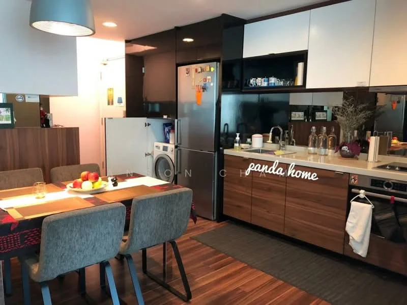 Kitchen features: stainless-steel fridge, built-in oven, 4-burner gas hob, single-bowl stainless-steel sink, chrome pull-down faucet, white cabinetry with wood accents, dark countertop, washing machine, dining table with 4 grey upholstered chairs, decorative fruit bowl on table, wooden flooring, recessed downlights, open shelving, kitchen island, wall-mounted cabinets; style: modern.