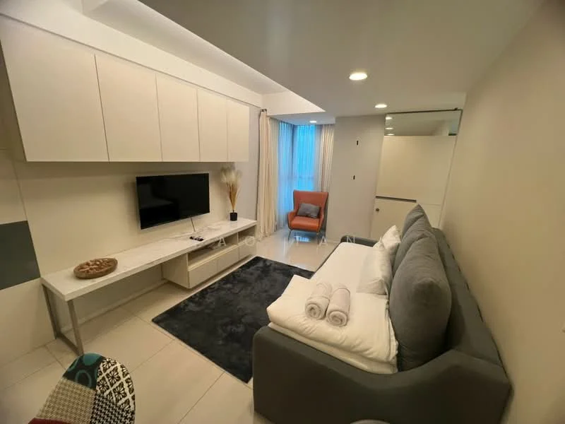 Living features: grey fabric sofa, white throw pillows, coffee table, wall-mounted TV, white media console, light-colored wall, recessed lighting, floor-to-ceiling window, curtains, area rug with dark color, accent chair in orange, decorative plant; style: modern.