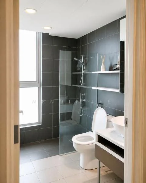 Bathroom features: grey tiled walls, white ceramic toilet, walk-in shower with glass enclosure, chrome shower head, wall-mounted shower controls, floating vanity with storage, white sink, open shelving, large window for natural light, grey tiled flooring, decorative vase on shelf; style: modern.