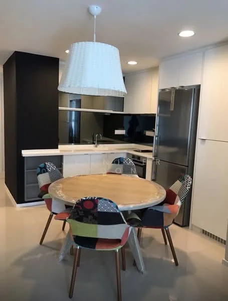 Kitchen features: round wooden dining table, 4 upholstered dining chairs with colorful fabric, white cabinetry, black accent wall, stainless-steel fridge, stainless-steel sink, chrome pull-down faucet, white pendant light, black countertop, mirror backsplash, recessed downlights, ceramic tile flooring; style: modern.