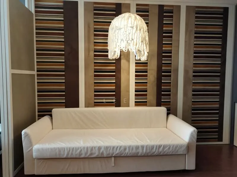 Living features: white fabric sofa, striped accent wall with brown and beige tones, wood flooring, chandelier with lace design, wall-mounted electrical outlet, decorative wall paneling; style: modern.
