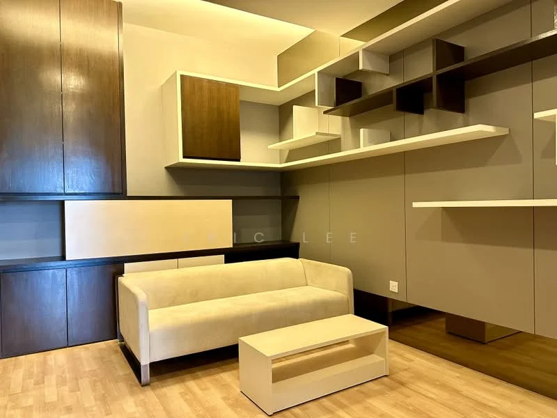 Living features: beige fabric sofa, wooden coffee table, built-in wall shelves in various shapes, light wood flooring, neutral wall color, ambient ceiling lighting, modern design elements; style: modern.
