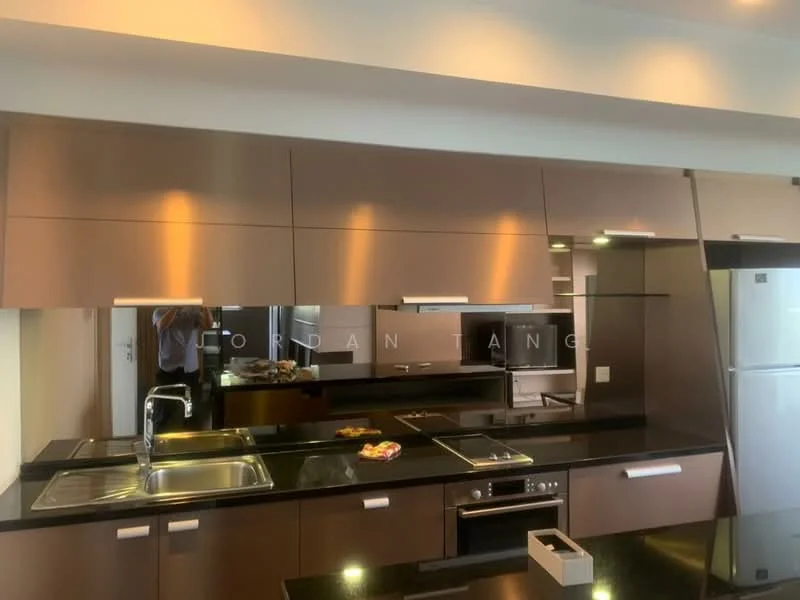 Kitchen features: dark wood cabinetry, black granite countertop, stainless-steel sink, chrome pull-down faucet, built-in oven, stainless-steel fridge, glass backsplash, recessed downlights, kitchen island, integrated cooktop; style: modern.