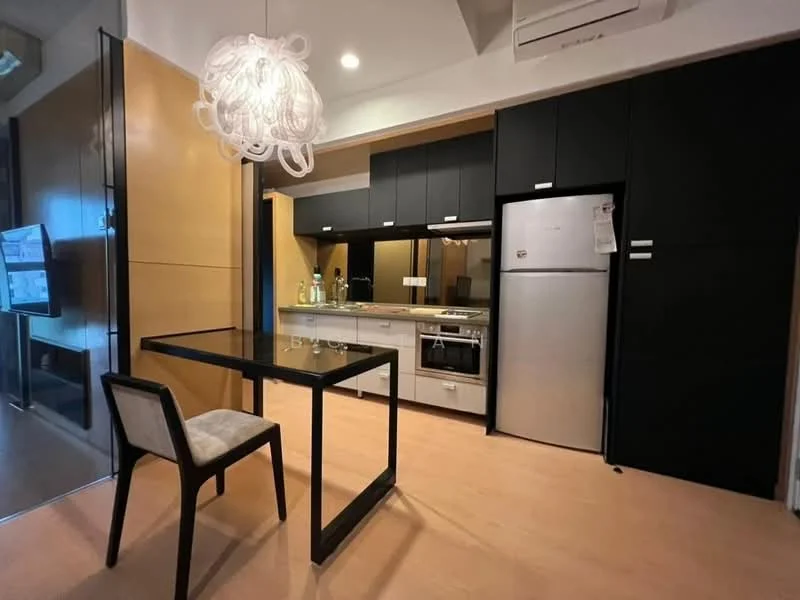 Kitchen features: black cabinetry, white countertop, stainless-steel fridge, built-in oven, 4-burner gas hob, exhaust hood, single-bowl stainless-steel sink, chrome pull-down faucet, pendant light, wooden flooring, glass dining table, upholstered dining chair, wall-mounted TV, recessed downlights; style: modern.
