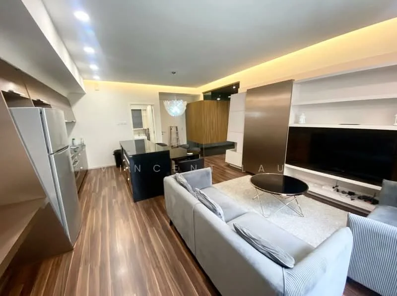 Living features: 3-seater fabric sofa in light grey, coffee table with black surface, wall-mounted TV, entertainment unit with storage, wooden flooring, recessed LED downlights, decorative wall paneling, open layout with kitchen area, floor-to-ceiling windows, modern light fixture; style: modern. Kitchen features: stainless-steel fridge, kitchen island with seating, built-in oven, induction cooktop, sleek cabinetry, marble countertop, recessed lighting; style: modern.