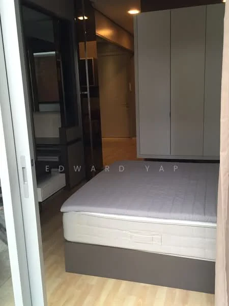 Bedroom features: queen-size bed base without mattress, built-in wardrobe with sliding doors, wooden flooring, neutral wall color, recessed ceiling lights, floor-to-ceiling windows, curtains, open layout to adjacent room; style: modern.