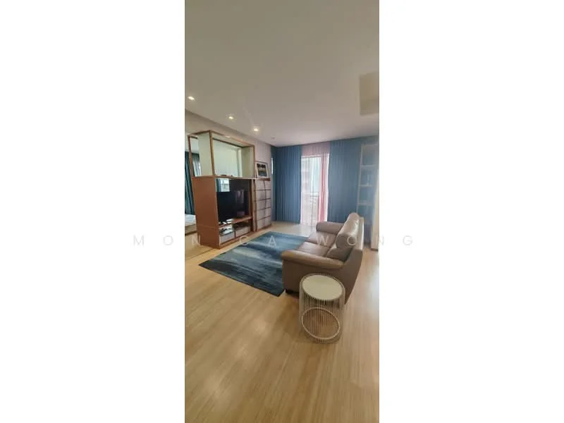 Living features: light wood flooring, beige fabric 2-seater sofa, white round side table, area rug in blue tones, wall-mounted TV, wooden TV console, built-in shelving unit, floor-to-ceiling windows with sheer curtains, decorative mirror, recessed ceiling lights; style: modern; view: city.