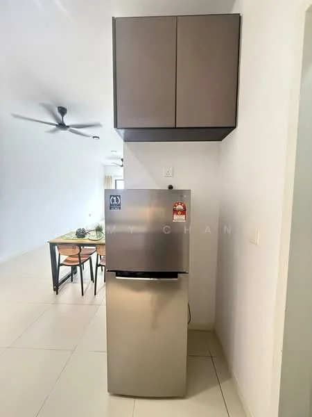Kitchen features: stainless-steel fridge, upper cabinetry in dark brown, white walls, cream tiled flooring, ceiling fan, dining table visible in background, chairs visible in background; style: modern.