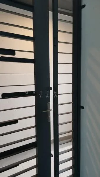 Room features: metal security door with horizontal slats, light grey wall, white ceiling, tile flooring, natural light from adjacent room; style: modern.