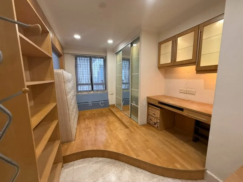 Room features: wooden flooring, built-in wooden shelving, built-in cabinets with glass doors, desk area with drawers, large window with grid pattern, neutral wall color, curved wooden platform, mattress leaning against wall, recessed lighting; style: modern.