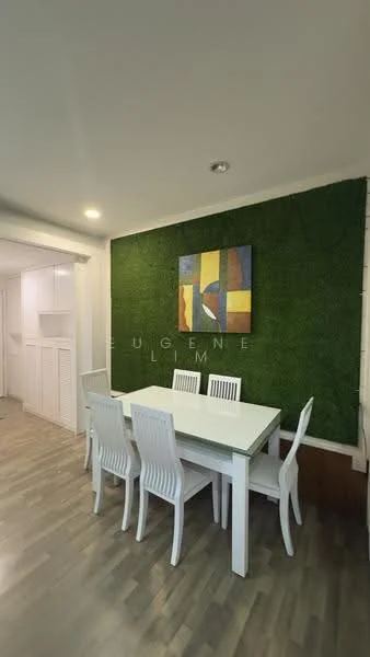 Dining features: white dining table, 6-seater dining table, white plastic dining chairs, green accent wall with artificial grass, wooden flooring, recessed ceiling lights, abstract wall art, open layout to adjacent room; style: modern.