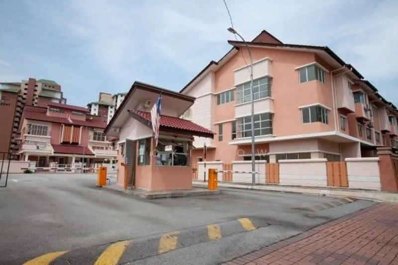 Exterior type: linked terrace house; features: pink painted facade, two-storey building, gated entrance, guard house at entrance, paved driveway, visible parking area, surrounded by other residential buildings, street view, flagpole with Malaysian flag; style: modern.