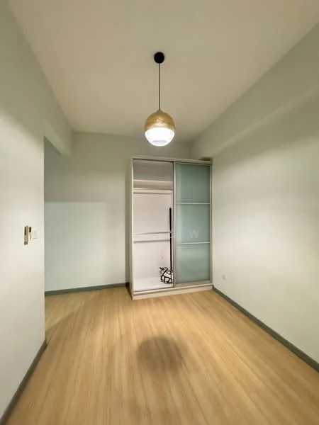 Room features: light wood laminate flooring, pale green painted walls, single pendant light fixture, built-in wardrobe with sliding glass doors, neutral ceiling, no visible windows, minimalist design; style: modern.