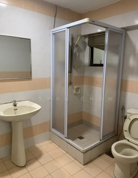 Bathroom features: white tiled walls, light peach accent tiles, shower cubicle with glass door, handheld shower head, white pedestal sink, mirror above sink, toilet, tile flooring, window for natural light, shower drainage, towel rack.