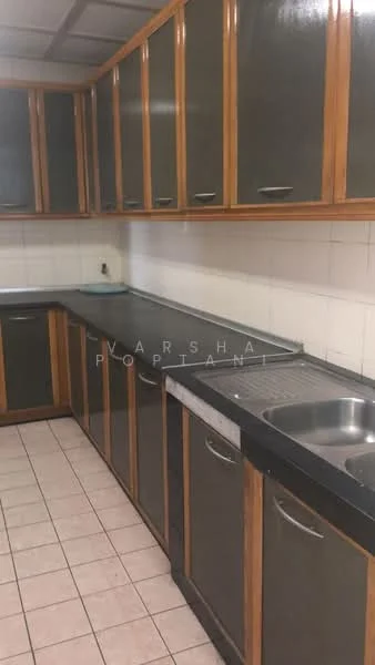 Kitchen features: L-shaped countertop, black granite countertop, wood cabinetry with glass fronts, stainless-steel sink, single-bowl sink, chrome faucet, white tiled backsplash, ceramic tile flooring, built-in cabinets, under-cabinet lighting.