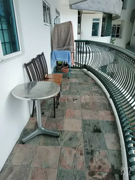 Balcony features: round table with metal base, 4 wooden chairs, slate tile flooring, railings with decorative design, towel hanging on railing, blue cloth draped over chair, potted plant.