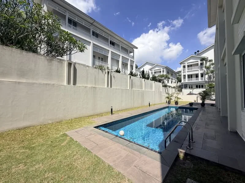 Exterior type: linked terrace house; features: swimming pool, pool deck with loungers, manicured lawn, tropical landscaping, white painted facade, two-storey building, surrounded by greenery, concrete wall, outdoor lighting; style: modern.