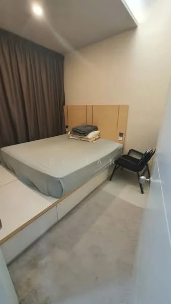 Bedroom features: queen-size bed, upholstered headboard, bedside table, black chair, grey bedding, cream painted walls, curtains, built-in wardrobe, carpet flooring; style: modern.