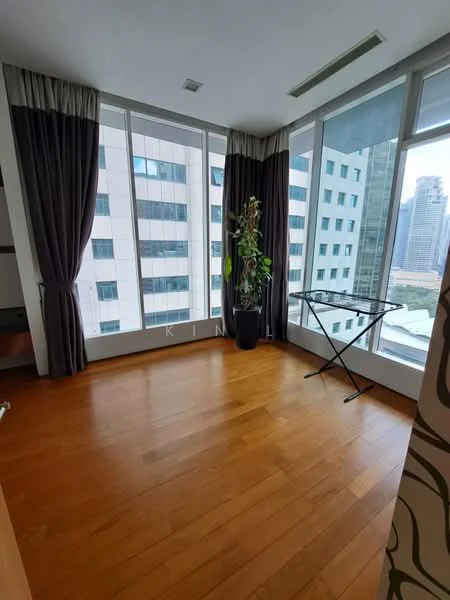 Room features: wood flooring, floor-to-ceiling windows, blackout curtains, sheer curtains, indoor plant, folding clothes drying rack, city view, neutral wall colour; style: modern; view: city.