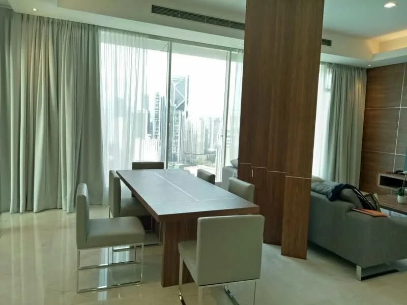 Dining features: rectangular wooden dining table, 4 upholstered dining chairs in grey, floor-to-ceiling windows, sheer curtains, marble flooring, city skyline view, decorative wall paneling, recessed downlights; style: modern; view: city. Living features: fabric sofa in grey, coffee table, decorative throw blanket, wall-mounted TV, built-in cabinetry, area rug, potted plant; style: modern; view: city.
