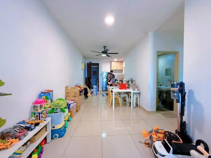 Room features: white painted walls, glossy tile flooring, 5-blade ceiling fan with light, dining table with chairs, kitchen visible in background, toys scattered on floor, storage shelves, refrigerator visible, open layout, natural light from window; style: modern.