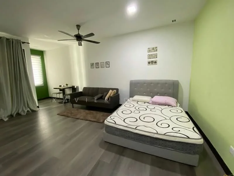 Room features: grey upholstered bed with mattress, black fabric sofa, area rug, 5-blade ceiling fan, green accent wall, white painted walls, laminate flooring, dining table with chairs, decorative wall art; style: modern.