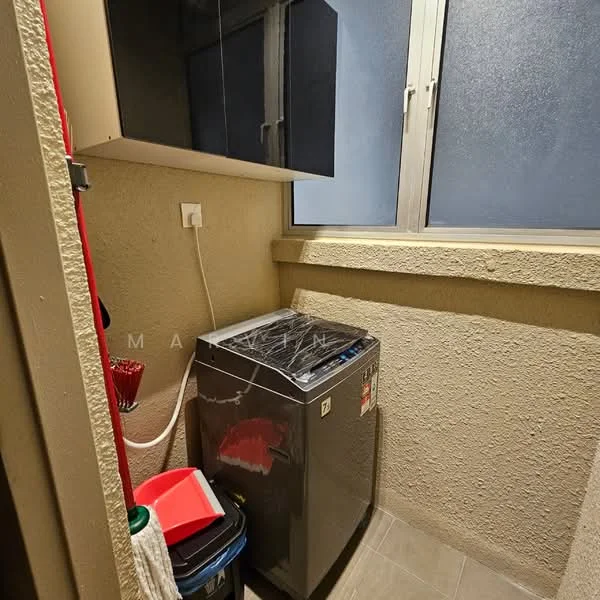 Laundry features: top-load washing machine, grey tiled flooring, light grey painted walls, window with frosted glass, black cabinetry above, red cleaning supplies, plastic trash bin.