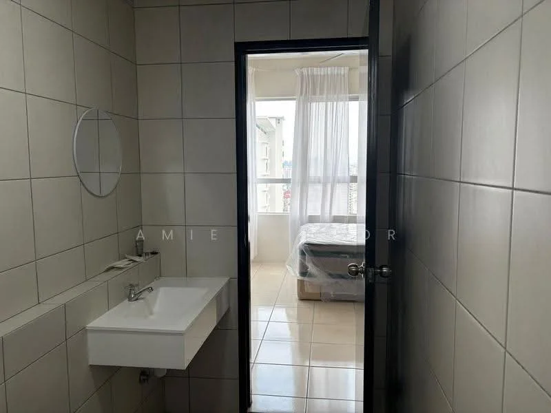 Bathroom features: white ceramic tile walls, light beige tile flooring, single-bowl wall-mounted sink, chrome basin mixer faucet, round mirror, door leading to another room; style: modern. Room features: bed visible through doorway, sheer curtains, natural light from window.