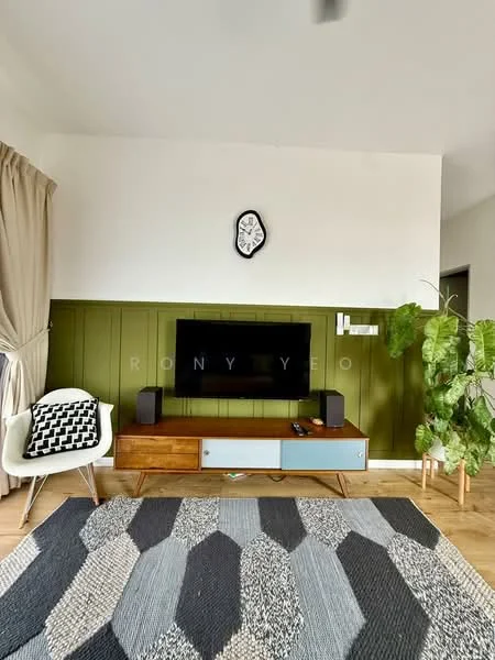 Living features: green accent wall, white painted walls, wooden flooring, flat-screen TV mounted on wall, wooden TV console with grey drawer, decorative wall clock, large indoor plant, area rug with geometric pattern, curtains, speakers on either side of TV; style: modern.
