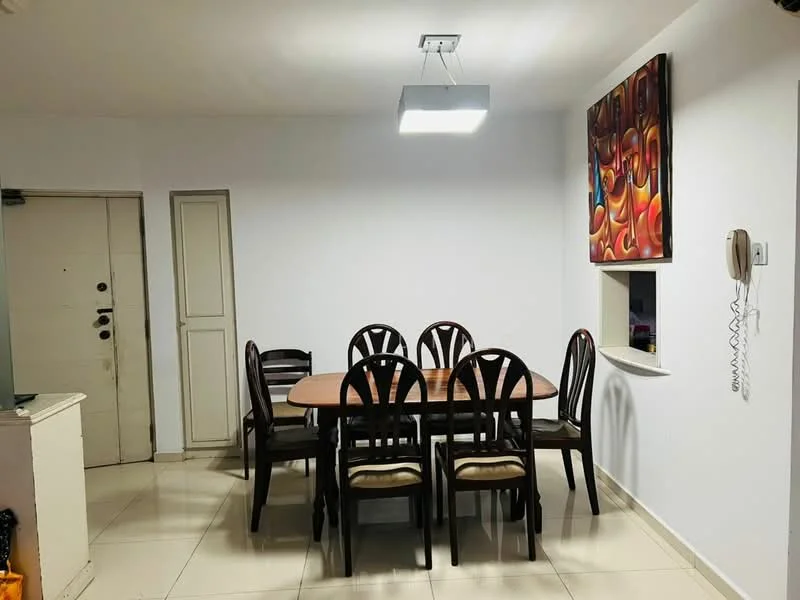 Dining features: 6-seater dining table, wooden dining chairs, white painted walls, tile flooring, ceiling-mounted light fixture, framed artwork on wall, wall-mounted intercom, niche with window, door leading to hallway; style: modern.