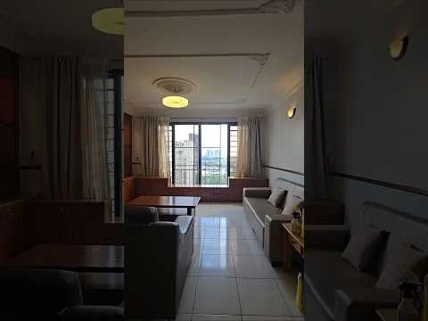 Living features: floor-to-ceiling windows, white painted walls, cream ceiling with crown moulding, recessed lighting, 2-seater fabric sofa in light grey, 3-seater fabric sofa in light grey, wooden coffee table, built-in cabinetry, curtains, tile flooring, city view; style: modern; view: city.