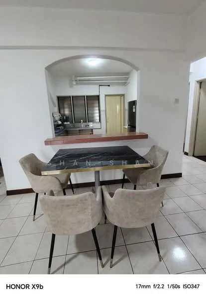 Dining features: 4 upholstered dining chairs in beige, round dining table with black marble top, white tiled flooring, wall-mounted air conditioning unit, open layout to kitchen, window with blinds, neutral wall color, light ceiling with no visible fixtures; style: modern. Kitchen features: kitchen countertop with bar overhang, kitchen cabinets visible in background, stainless-steel appliances visible, open layout to dining area; style: modern.