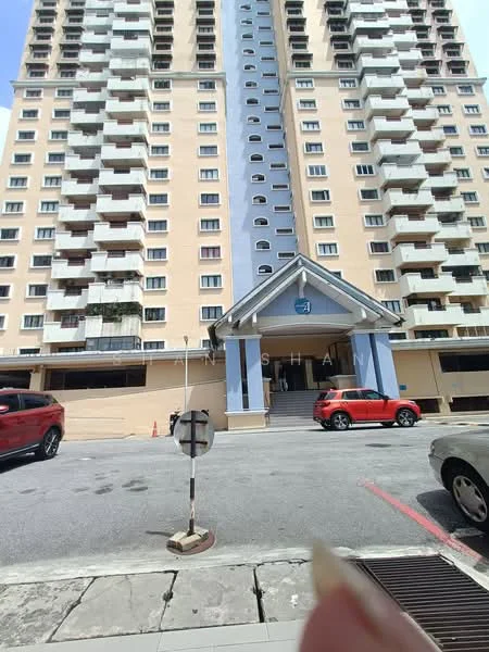 Exterior type: mid-rise condominium; features: cream painted facade, blue accent panels, recessed balconies, multiple storeys, main entrance with awning, parking area visible, surrounded by urban context; style: modern.