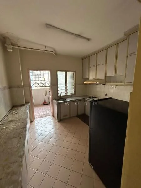 Kitchen features: white cabinetry with gold handles, black refrigerator, grey countertop, ceramic tile flooring, window with metal grille, open layout to balcony, exposed plumbing, wall-mounted light fixture.