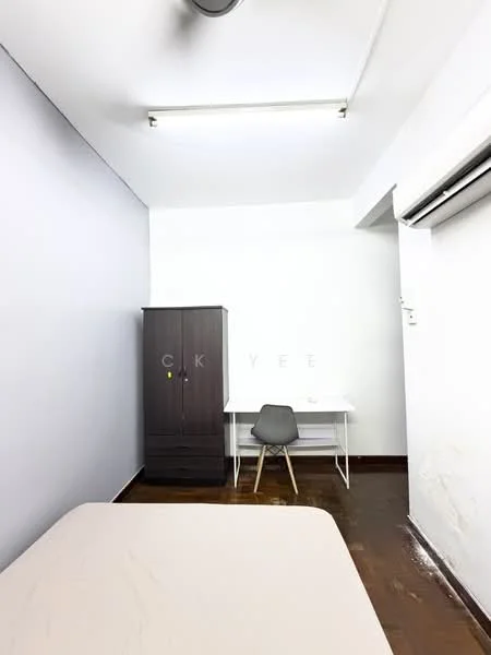 Bedroom features: light grey painted walls, wooden flooring, single bed with beige bedding, dark wood wardrobe, white study desk, grey chair, ceiling light fixture, wall-mounted air conditioning unit; style: minimalist.