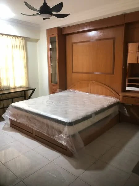 Bedroom features: queen-size bed with mattress covered in plastic, wooden headboard, built-in wooden wardrobe with mirror, wooden bedside table, ceiling fan, cream painted walls, tile flooring, curtains on window; style: modern.