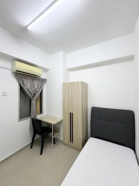 Bedroom features: single bed with white mattress, grey upholstered headboard, wooden wardrobe with two doors, study desk with chair, window with sheer curtains, wall-mounted air conditioning unit, light grey tiled flooring, white painted walls, ceiling light fixture; style: modern.