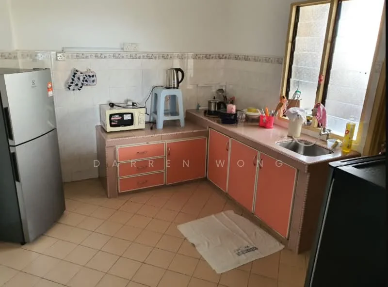 Kitchen features: grey fridge, microwave, kitchen countertop with pink laminate finish, single-bowl stainless-steel sink, chrome pull-down faucet, wooden cabinetry with pink doors, tile backsplash, ceramic tile flooring, window with grid pattern, kettle, dish soap dispenser, cleaning supplies, floor mat.