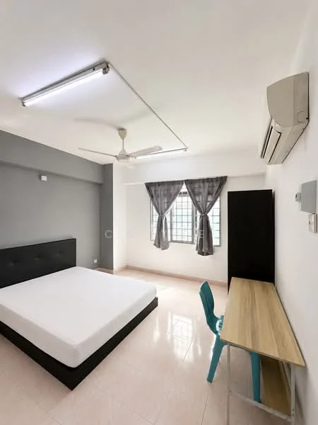 Bedroom features: white painted walls, grey accent wall, polished tile flooring, 5-blade ceiling fan, window with sheer curtains, built-in wardrobe, study desk with wooden top, plastic chair, air conditioning unit; style: modern.