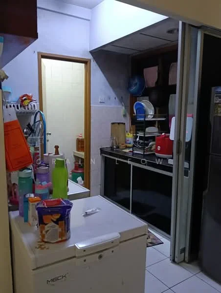 Kitchen features: white tiled walls, ceramic tile flooring, built-in cabinets, stainless-steel refrigerator, freestanding stove with oven, double-basin sink, chrome faucet, countertop with appliances, open shelving, various cleaning supplies, kitchen utensils, plastic containers, bottled drinks.
