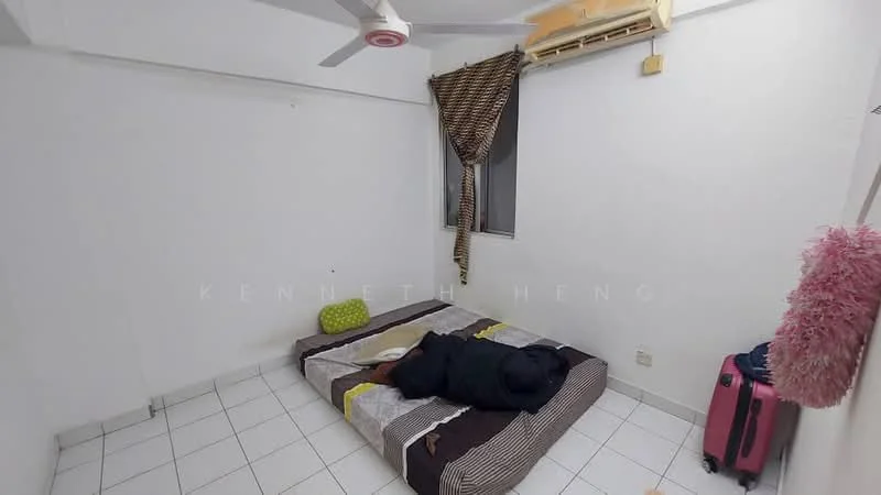 Bedroom features: white painted walls, white tiled flooring, single bed with bedding, ceiling fan, window with sheer curtains, air conditioning unit, decorative wall hanging, pink decorative item on wall, suitcase, green cushion.