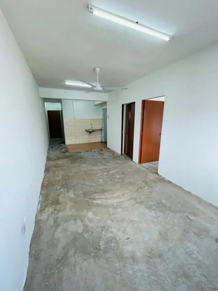 Room features: white painted walls, concrete flooring, ceiling fan, kitchenette area with sink, two doorways leading to other rooms, fluorescent ceiling lights; style: minimalist.