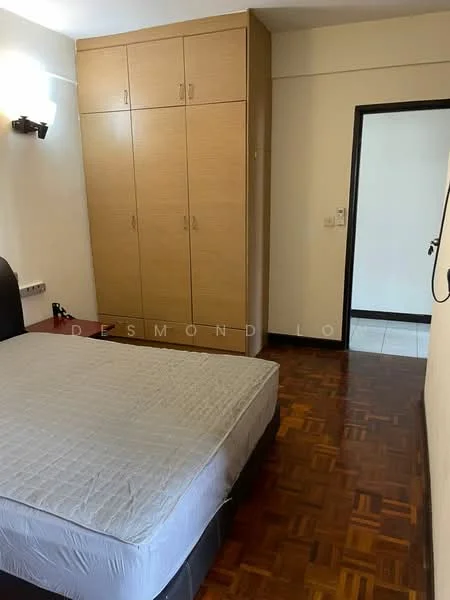 Bedroom features: wooden flooring, built-in wardrobe with sliding doors, queen-size bed base, wall-mounted light fixture, neutral wall color, doorway leading to another room, window with no visible treatment, decorative wall paneling; style: modern.