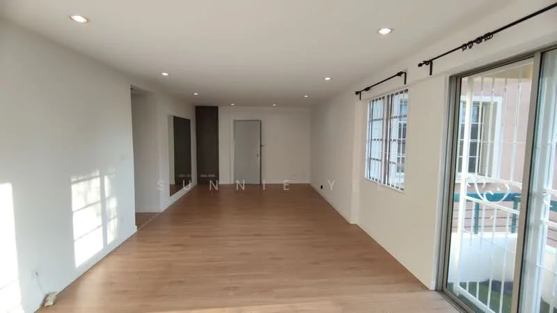 Living features: light wood laminate flooring, white painted walls, recessed downlights, floor-to-ceiling windows, sliding glass door, window treatments with sheer curtains, neutral color scheme, open layout; style: modern.