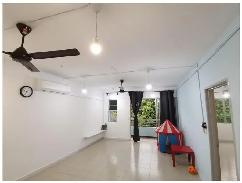 Living features: white painted walls, tile flooring, 5-blade ceiling fan, 2 wall-mounted split AC units, recessed downlights, clock on wall, blackout curtains, large windows with garden view, red play tent, red table, orange ball; style: modern; view: garden.