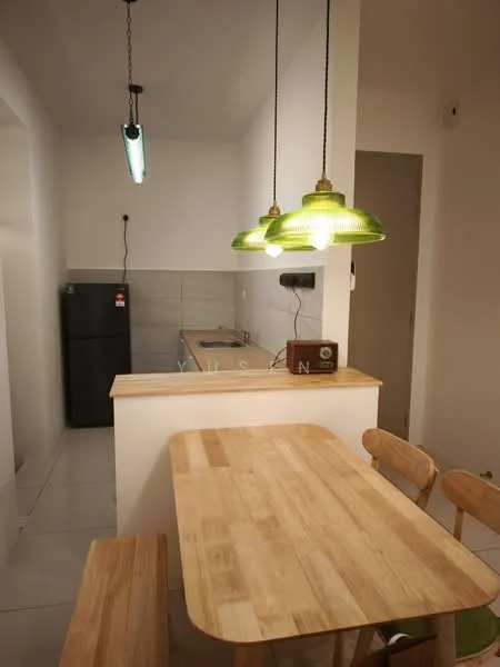 Kitchen features: white painted walls, ceramic tile flooring, pendant lighting with green glass shades, wooden dining table, wooden bench seating, stainless-steel fridge, kitchen countertop, sink, wall-mounted kitchen cabinet, tile backsplash; style: modern.